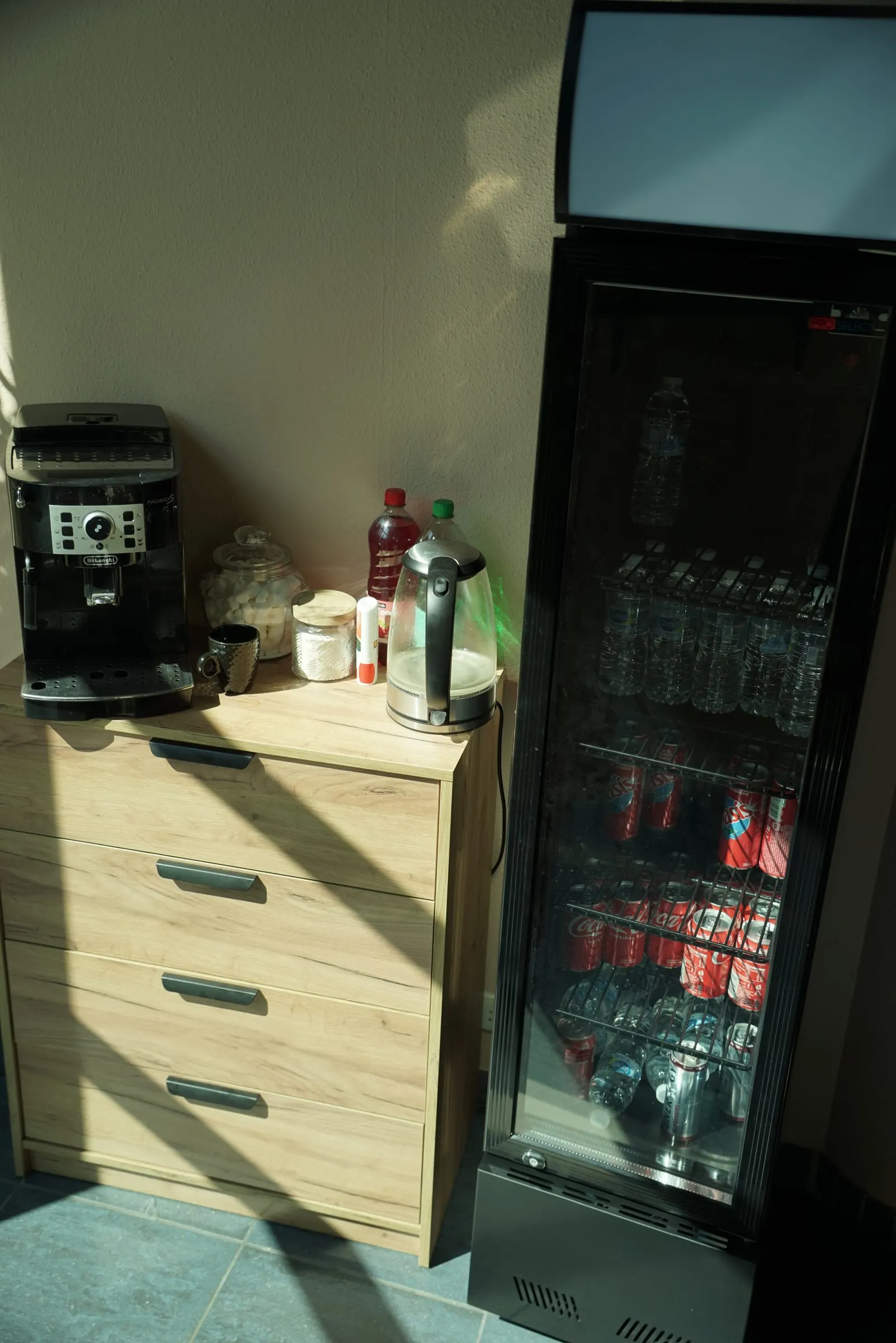 Koffiemachine en koelkast met flesjes drinken voor klanten